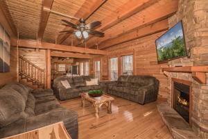 a living room with a fireplace in a log cabin at Indoor Pool Beauty in Cosby