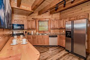 a kitchen with wooden cabinets and a stainless steel refrigerator at Indoor Pool Beauty in Cosby