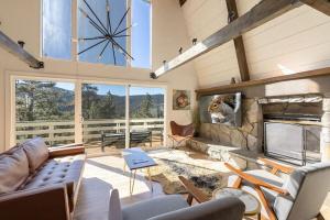 a living room with a couch and a fireplace at The Drey in Big Bear City