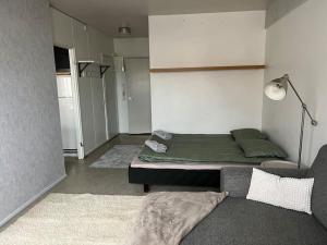 a living room with a bed and a couch at Apartment Kopin3 in Kokkola