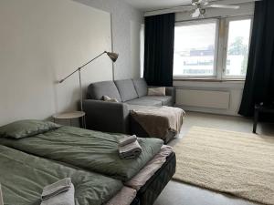 a living room with a bed and a couch at Apartment Kopin3 in Kokkola