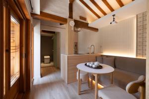 a living room with a couch and a table at Luxury Hanok Cottage Lunar in Seoul +2 photos