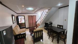 a living room with a dining room table and chairs at EV2 Townhouse Hotel in Angeles