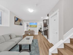 a living room with a couch and a table at Stylish 2-Bedroom Apartment In Downtown Windsor in Windsor +6 photos