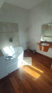 a bathroom with a white tub and a sink at Domaine du prieuré Saint Ellier in  Charcé-Saint-Ellier-sur-Aubance +9 photos