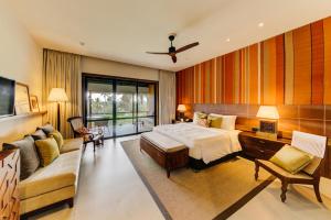 a hotel room with a bed and a couch at Cinnamon Bentota Beach - Signature Selection in Bentota
