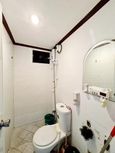 a bathroom with a toilet and a shower at Calapan Transient House 3-BedRoom near MALLS L26 in Calapan