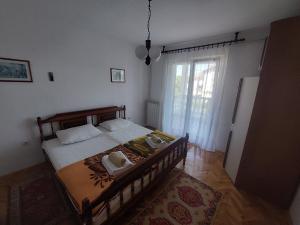 a bedroom with a bed with two candles on it at Milka Apartments in Njivice