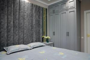 a bedroom with a bed and a wall at Learmara Apartment #2 in Samarkand