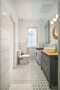 a bathroom with a toilet and a sink at Downtown apartment 2 minutes from Opera House in Budapest