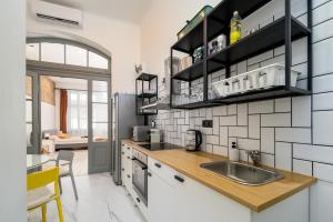 a kitchen with a sink and a counter at Downtown apartment 2 minutes from Opera House in Budapest +8 photos