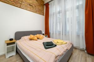 a bedroom with a bed with two cats laying on it at Downtown apartment 2 minutes from Opera House in Budapest