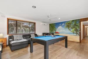 a living room with a ping pong table in it at Hacienda Retreat- 27 guests in Capel Sound