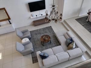 an overhead view of a living room with a couch and chairs at Beach Club Self Catering Apartments in Mossel Bay