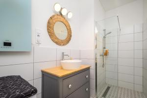 a bathroom with a sink and a mirror at Downtown apartment 2 minutes from Opera House in Budapest