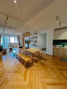 a living room with a wooden table and a kitchen at International Plaza, District 1 in Ho Chi Minh City