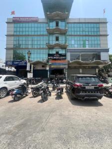 a parking lot with motorcycles parked in front of a building at Hotel mauji's legacy in Allahābād