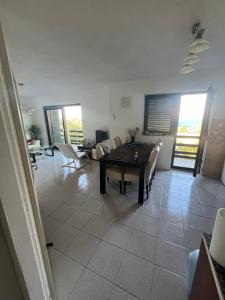 a living room with a table and chairs at Vila Gioya in Karlobag