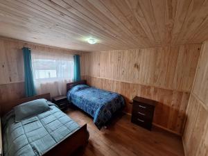 Ένα ή περισσότερα κρεβάτια σε δωμάτιο στο Cabaña Los Chilcos - Neltume - Huilo Huilo