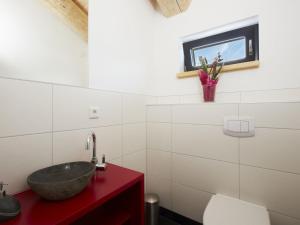 a bathroom with a sink and a red counter at Chalet in Ladis by Ski Slope & Sonnenbahn in Ladis +30 photos
