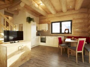 a kitchen with a table and a television in a room at Chalet in Ladis by Ski Slope & Sonnenbahn in Ladis