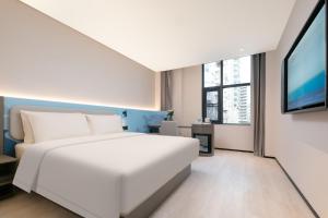 Voodi või voodid majutusasutuse Atour Light Hotel Wuhan Wanxiang City Xinhua Road toas