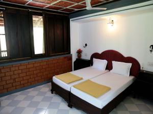 Vuode tai vuoteita majoituspaikassa Kairali Palace Home Stay