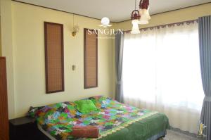 Letto o letti in una camera di Sangjun On Beach Resort