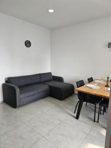a living room with a couch and a table at Gonio Apartment Seaview in Kvariati
