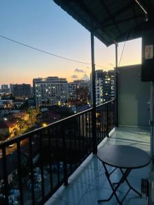 a balcony with a table and a view of a city at flat in P'eria