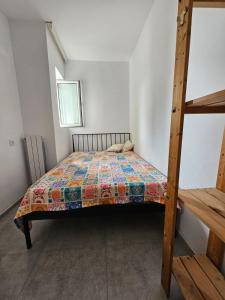 a bedroom with a bed with a quilt on it at Gonio Apartment Seaview in Kvariati