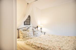 a bedroom with a bed with a canopy at Immenhagen Ferienwohnungen in Malente