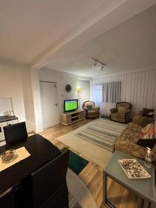 a living room with a couch and a tv at House For Stay in Pristina