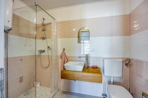 a bathroom with a sink and a shower at Apartments Galeb in Poreč +21 photos
