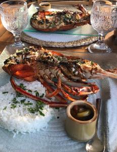 a plate of food with rice and seafood on a table at Le Jardin des Portes in Les Portes