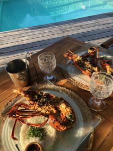 a table with two plates of food on it at Le Jardin des Portes in Les Portes +64 photos