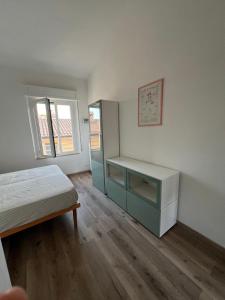 a bedroom with a bed and a desk in it at La casa di Pi in Montacuto