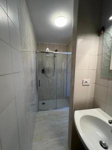 a bathroom with a shower and a sink at La casa di Pi in Montacuto