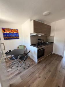a kitchen with a table and chairs in a room at La casa di Pi in Montacuto +8 photos