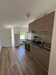 a kitchen with wooden cabinets and a stove top oven at La casa di Pi in Montacuto