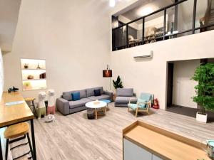 a living room with a couch and a table at 花蓮後站-沐青文旅 in Hualien City