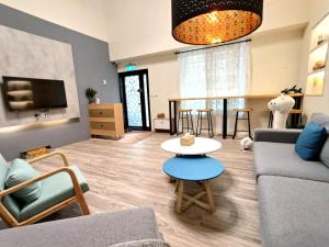 a living room with a couch and a table at 花蓮後站-沐青文旅 in Hualien City +25 photos