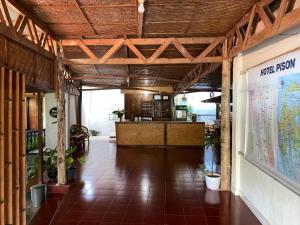 a large room with a bar in a building at Hotel Pison in Rantepao