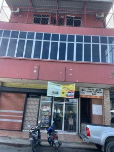two motorcycles parked in front of a building at Tabin Lodge Budget Stay in Lahad Datu