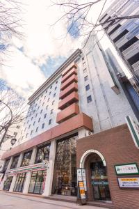 a building on a city street with a building at Hotel Johzenji in Sendai