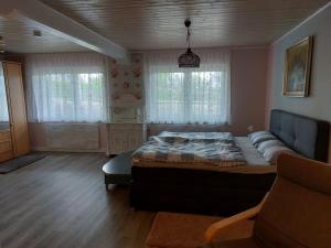 a bedroom with a large bed and a couch at Hotel MOMA in Nagel