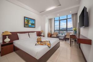 a hotel room with a bed and a desk and a room at Star Hotel and Spa Danang in Danang
