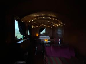 a small room with a bed and a window at Eco Crofter's Wagon by the Sea - Off Grid Experience - No electricity - As seen soon on Netflix in Oldshoremore