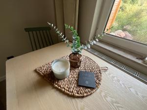 a table with a vase and a bowl on a table at Bungalow Green Park in Benz