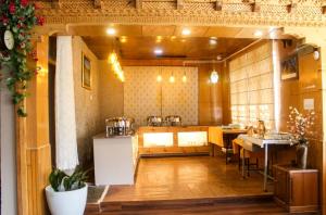 a large room with a kitchen and a table at Kanishka Hotel Ladakh by LexStays in Leh